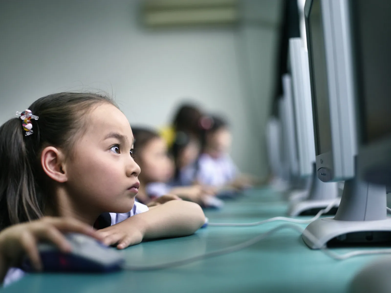 A pupil working at a computer in an ICT suite